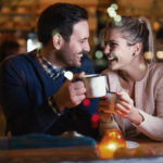 Happy attractive couple talking at bar having date