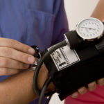 Doctor or nurse taking a patient’s blood pressure