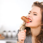 people, diet, culinary and food concept – hungry young woman eat