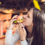 Young Woman Eating Hamburger Woman Eating Junk Food, Fatty Food