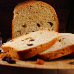 homemade white sweet bread with raisins and ears of wheat