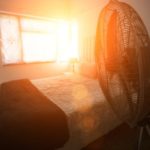 electric-fan-next-to-bed-with-sunshine-coming-royalty-free-image-1014266060-1559935075