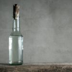 white-vinegar-bottle-on-wood-table